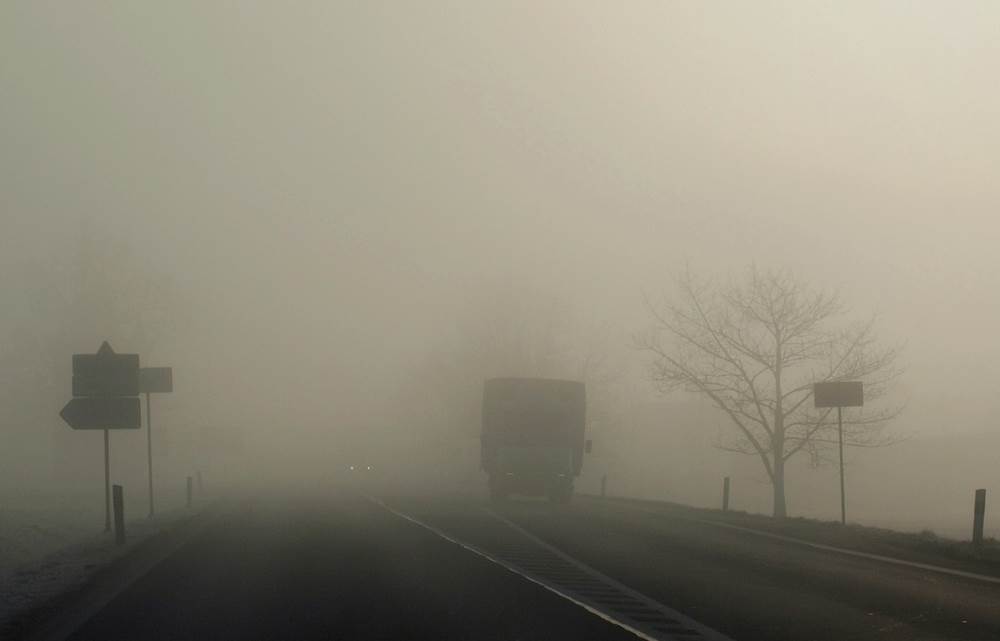 foggy road with approaching truck
