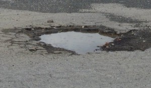 asphalt-pot-hole-with-puddle