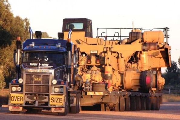 Lowboy trailer with mining equipment on the back