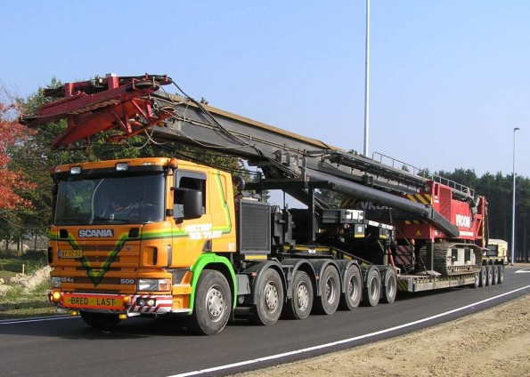 Heavy crane being transported on a lowboy trailer