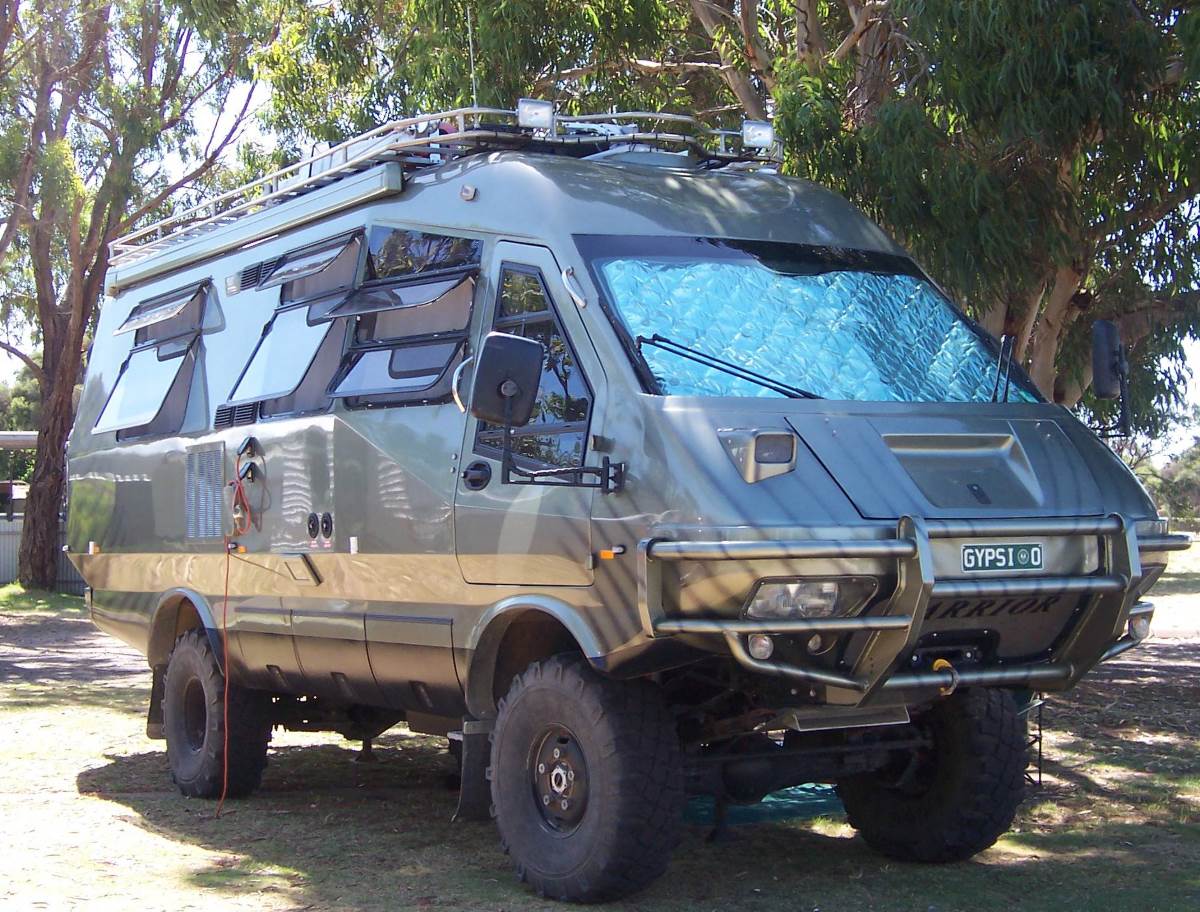off-road motor home parked partially in the shade