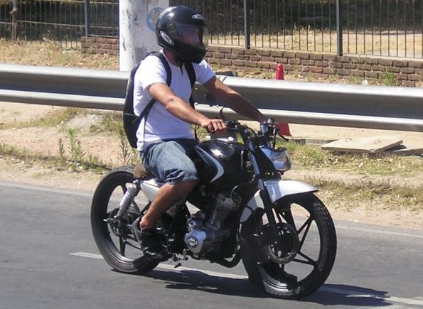 Motorbike rider in shorts and t-shirt